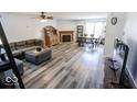 Open concept living room with wood burning fireplace, new flooring, and dining area at 6213 Selago Dr, Indianapolis, IN 46203