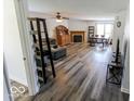 Spacious living room featuring new flooring, a fireplace, and ample natural light at 6213 Selago Dr, Indianapolis, IN 46203