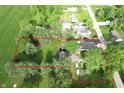 Aerial view of property surrounded by mature trees, lush lawn, and bordered with a defined red perimeter line at 71 W County Road 500 S, Clayton, IN 46118