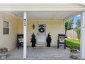 Covered porch featuring a welcoming entrance with wreaths and potted plants at 71 W County Road 500 S, Clayton, IN 46118