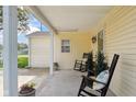 Inviting covered porch with rocking chairs and views of the front yard at 71 W County Road 500 S, Clayton, IN 46118