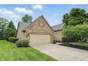 Single-Gathering home with a two-car garage, manicured lawn and shrubbery at 7329 Pymbroke Dr, Fishers, IN 46038