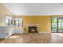 Sunlit living room featuring a fireplace, window seating, and sliding glass doors at 740 Carya Sq, Columbus, IN 47201
