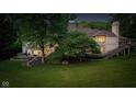 Beautiful backyard with mature trees, patio, and staircase at 7624 William Penn Pl, Indianapolis, IN 46256