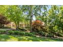 Beautiful home with mature landscaping and stone accents at 7624 William Penn Pl, Indianapolis, IN 46256