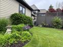 Lush backyard garden with a stone lantern, various plants and shrubs at 7661 Carriage House Way, Zionsville, IN 46077