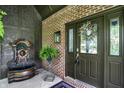 Inviting front entrance with brick accent wall, fountain, and wreath on the glass-paneled front door at 7661 Carriage House Way, Zionsville, IN 46077