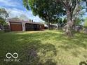 Expansive backyard with mature trees and plenty of space for outdoor activities at 7842 Brennan Rd, Indianapolis, IN 46219
