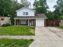 Inviting two-story home with a well-manicured lawn, covered entryway, and attached single car garage at 8030 Winchester Pl, Indianapolis, IN 46227