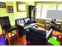 Cozy living room features a leather sofa and hardwood floors at 8357 Harrison Dr, Lawrence, IN 46226