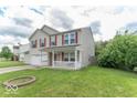 This delightful two-story house has an attached garage and a cozy covered porch at 8712 Mellot Way, Camby, IN 46113