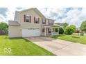 This lovely home boasts a spacious driveway, a well-manicured lawn, and inviting curb appeal at 8712 Mellot Way, Camby, IN 46113