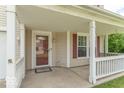 The covered front porch is perfect for relaxing with its charming porch swing and welcoming entrance at 8712 Mellot Way, Camby, IN 46113