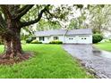 Well-maintained single-story home with two-car garage and cracked driveway at 9098 W 1050 N, Elwood, IN 46036