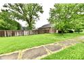 Spacious backyard with green lawn and wood fence bordering the property at 924 S B St, Elwood, IN 46036