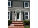 Inviting front entrance with brick steps and classic white trim at 9650 Copley Dr, Carmel, IN 46290