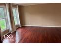 Bright living room with hardwood floors and large windows at 9650 Copley Dr, Carmel, IN 46290