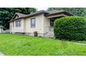 Cozy single-Gathering home featuring neutral siding, mature landscaping, and a welcoming front porch at 100 N 6Th Ave, Beech Grove, IN 46107