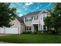 Charming two-story home with blue shutters, well-maintained lawn, and mature trees at 1029 Bridgeport Dr, Westfield, IN 46074