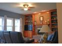 Living room with a brick fireplace, built-in shelves, a ceiling fan and large windows for lots of light at 1029 Bridgeport Dr, Westfield, IN 46074