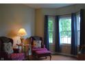 Comfortable sitting area with two chairs, a small table, and bright windows with blue curtains at 1029 Bridgeport Dr, Westfield, IN 46074