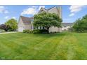 Spacious, well-manicured lawn with mature trees adding to the home's curb appeal at 1029 Bridgeport Dr, Westfield, IN 46074