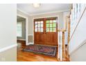 Welcoming entryway boasting hardwood floors, elegant trim, and a stylish front door at 10627 Indian Lake S Blvd, Indianapolis, IN 46236