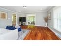 Bright living room features hardwood floors, neutral paint, and an open floor plan at 10627 Indian Lake S Blvd, Indianapolis, IN 46236