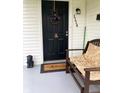 Inviting front porch with a bench, wreath, and decorative lion statue by the door at 1114 N Olney St, Indianapolis, IN 46201