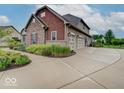 A three car garage and manicured landscaping add to the beauty of this home at 11521 Willow Bend Dr, Zionsville, IN 46077