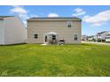 Backyard with lawn, patio, dining set, grill and view of other houses in the community at 13887 N Hawkers Hill Dr, Camby, IN 46113