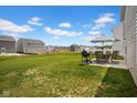 Green backyard featuring a grill, table, umbrella and view of adjacent properties at 13887 N Hawkers Hill Dr, Camby, IN 46113