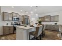Modern kitchen with stainless steel appliances, an island with counter seating, and stylish pendant lighting at 14866 E Keenan Cir # Lot 38, Westfield, IN 46074