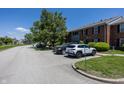 Exterior view of a well-maintained condo complex and lush green landscape at 1602 Queensbridge Sq # 7, Indianapolis, IN 46219
