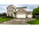 Inviting home featuring a brick facade, three-car garage, and a neatly maintained front yard at 16126 Etna Green, Westfield, IN 46074