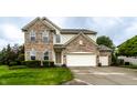 Beautifully maintained two-story home with a brick and siding exterior, lush lawn, and an attached garage at 16126 Etna Green, Westfield, IN 46074