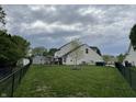 Large backyard with a small shed and a black chain link fence at 1713 Williamsburg Cir, Franklin, IN 46131