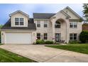 Beautiful two-story brick home with a well-maintained lawn and an attached garage at 1713 Williamsburg Cir, Franklin, IN 46131