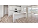Modern kitchen with white cabinets, stainless steel appliances, and a large center island at 18967 Seaforth Way, Westfield, IN 46074