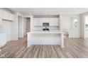 Bright kitchen featuring a center island, white cabinetry, and stainless steel microwave at 18967 Seaforth Way, Westfield, IN 46074