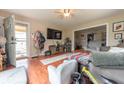 Cozy living area featuring hardwood floors, comfortable seating, and a view into the adjacent dining room at 1913 Pennsylvania St, Columbus, IN 47201