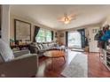 Bright living room with hardwood floors, a comfortable sofa, and large windows for ample natural light at 1913 Pennsylvania St, Columbus, IN 47201