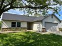 Well-maintained single-Gathering home with an attached garage and beautifully landscaped front yard at 199 Fountain Lake S Dr, Shelbyville, IN 46176