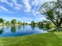 Beautiful lake with lush green grass and foliage surrounding it at 199 Fountain Lake S Dr, Shelbyville, IN 46176