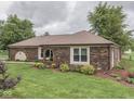 Beautiful brick home with well-maintained landscaping and mature trees in a serene setting at 2010 Alexandria Dr, Greenfield, IN 46140