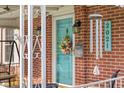Close-up of a charming front door featuring a wreath, decorative mailbox, and house number at 2021 Chestnut St, Columbus, IN 47201