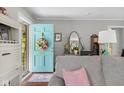 View of the living room showcasing a charming blue door and comfortable seating area at 2021 Chestnut St, Columbus, IN 47201