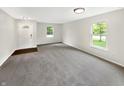 Spacious living room with neutral paint, large windows offering natural light, and plush carpeting at 2116 Orchid Bloom Dr, Indianapolis, IN 46231