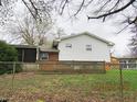 Fenced backyard features a wooden deck adjacent to the house, offering outdoor living and entertainment space at 2414 Constellation Dr, Indianapolis, IN 46229
