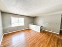 Open living room with beautiful wood floors and freshly painted gray walls at 2419 Tamarack Pl, Anderson, IN 46011